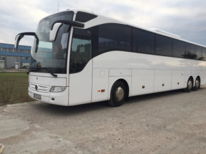 Biały autobus z firmy przewozu osób czeka na klientów na parkingu w Warszawie, transport osób Warszawa
